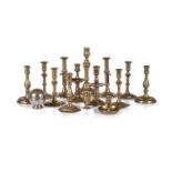 A GROUP OF TWELVE VARIOUS BRASS CANDLESTICKS