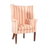 A MAHOGANY AND UPHOLSTERED WING ARMCHAIR IN GEORGE II STYLE