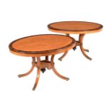 Y A PAIR OF SATINWOOD AND ROSEWOOD CROSSBANDED OVAL CENTRE TABLES IN REGENCY STYLE