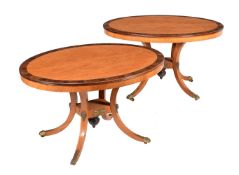 Y A PAIR OF SATINWOOD AND ROSEWOOD CROSSBANDED OVAL CENTRE TABLES IN REGENCY STYLE