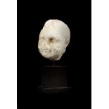 A FRAGMENTARY ANCIENT MARBLE HEAD OF A PUTTO OR EROS, ROMAN, CIRCA 1ST - 2ND CENTURY A.D