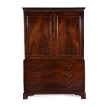 A GEORGE III FIGURED MAHOGANY CLOTHES PRESS, IN THE MANNER OF THOMAS CHIPPENDALE