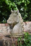 A SET OF FOUR STONE COMPOSITION HORSE HEAD FINIALS, 20TH CENTURY