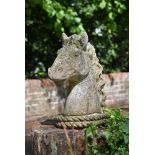 A SET OF FOUR STONE COMPOSITION HORSE HEAD FINIALS, 20TH CENTURY