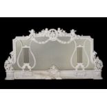 A CARVED AND WHITE PAINTED OVERMANTLE MIRROR, IN GEORGE III STYLE, LATE 19TH/EARLY 20TH CENTURY