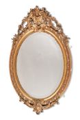 A GILTWOOD AND GESSO OVAL WALL MIRROR, IN 18TH CENTURY STYLE