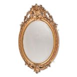 A GILTWOOD AND GESSO OVAL WALL MIRROR, IN 18TH CENTURY STYLE