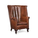 A LEATHER UPHOLSTERED WING ARMCHAIR, EARLY 20TH CENTURY