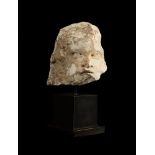 A FRAGMENTARY ANCIENT MARBLE HEAD OF A PUTTO OR EROS, ROMAN, CIRCA 1ST - 2ND CENTURY A.D