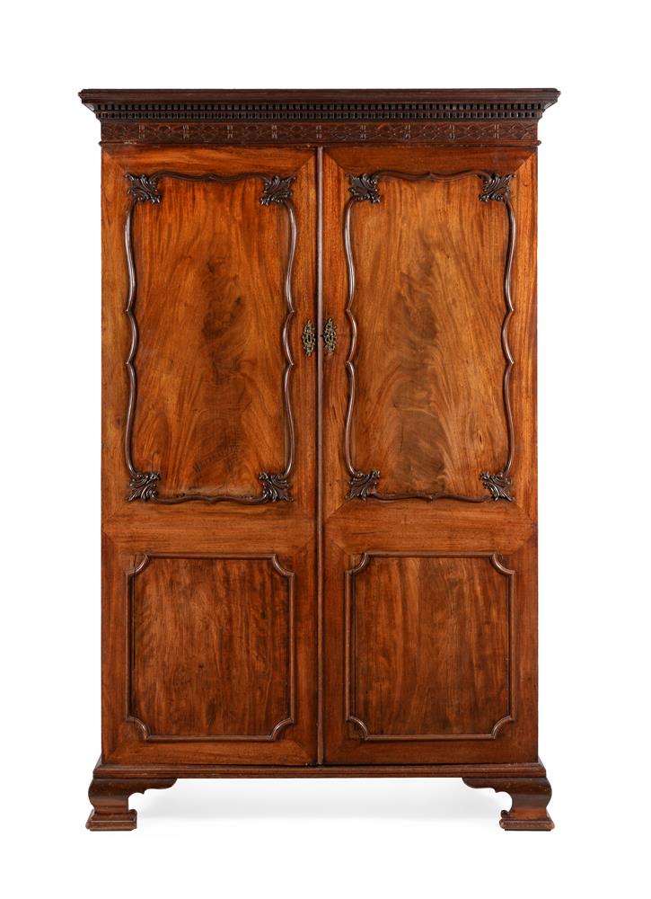 A GEORGE III MAHOGANY WARDROBE, IN THE MANNER OF THOMAS CHIPPENDALE, CIRCA 1770