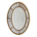 A GILTWOOD AND GESSO OVAL WALL MIRROR, LATE 18TH/EARLY 19TH CENTURY