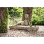 A LARGE COMPOSITION STONE FIGURE OF A RECUMBENT HOUND, 20TH CENTURY