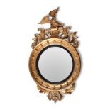 A REGENCY GILTWOOD CONVEX WALL MIRROR, CIRCA 1815