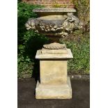 A LARGE STONE COMPOSITION TWIN HANDLED URN ON STAND, POSSIBLY AFTER AN 18TH CENTURY FRENCH DESIGN