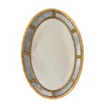 A GEORGE III GILTWOOD OVAL WALL MIRROR, CIRCA 1785