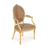 A GEORGE III PAINTED AND PARCEL GILT OPEN ARMCHAIR, IN THE MANNER OF JOHN LINNELL