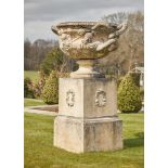 A LARGE CAST STONE WARWICK VASE AND PEDESTAL, IN THE MANNER OF COADE