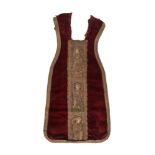 A CHASUBLE FRAGMENT, THE RED VELVET FIELD WITH EARLIER ORPHREY WOVEN WITH THREE SAINTS