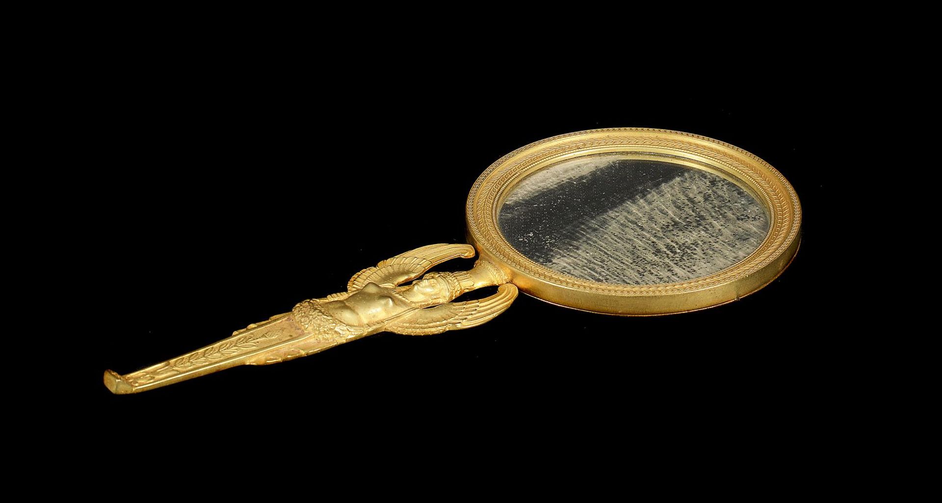 A GILT BRONZE HAND MIRROR, IN THE EMPIRE EGYPTIAN REVIVAL MANNER, FRENCH, 19TH CENTURY