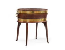 A GEORGE III MAHOGANY AND BRASS BOUND WINE COOLER, IN THE MANNER OF THOMAS CHIPPENDALE