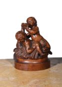 A CARVED BOXWOOD FIGURAL GROUP OF CAVORTING PUTTI, FLEMISH 18TH CENTURY