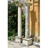 A LARGE PAIR OF CAST STONE COLUMNS WITH SCROLLING FLORAL CAPITALS, 20TH CENTURY