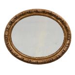 A PAIR OF ITALIAN CARVED GILTWOOD OVAL WALL MIRRORS, LATE 18TH/EARLY 19TH CENTURY