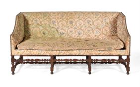 A WALNUT AND EMBROIDERY UPHOLSTERED SOFA, CIRCA 1710 AND LATER