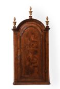 A QUEEN ANNE WALNUT AND FEATHER BANDED DOMED TOP HANGING CORNER CUPBOARD, CIRCA 1710