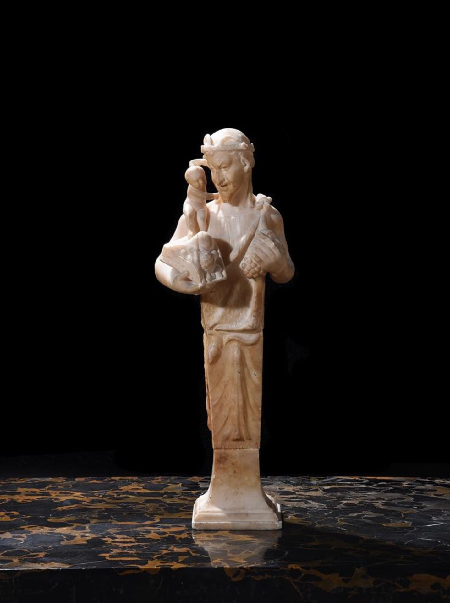 A CARVED ALABASTER HERM DEPICTING A SATYR WITH INFANT BACCHUS, ITALIAN, LATE 18TH/EARLY 19TH CENTURY