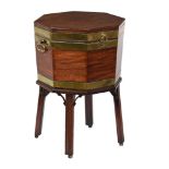 A GEORGE III MAHOGANY AND BRASS BOUND OCTAGONAL CELLARET, CIRCA 1780