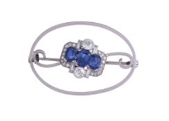A SAPPHIRE AND DIAMOND CLUSTER BROOCH