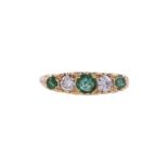 AN EMERALD AND DIAMOND FIVE STONE RING