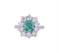 AN EMERALD AND DIAMOND CLUSTER RING