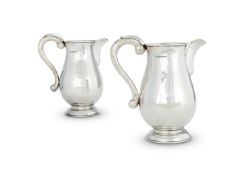 GUILD OF HANDICRAFT, A PAIR OF SILVER HAMMERED BALUSTER JUGS
