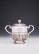 A SILVER TWIN HANDLED CUP AND COVER