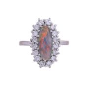 A BLACK OPAL AND DIAMOND CLUSTER RING, LONDON 1975