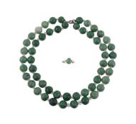 A JADEITE AND DIAMOND RING AND A GREEN HARDSTONE NECKLACE