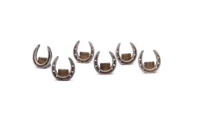 A CASED SET OF SIX SILVER HORSESHOE MENU HOLDERS