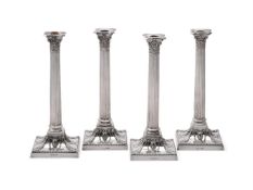 A SET OF FOUR ELECTRO-PLATED CORINTHIAN CANDLESTICKS