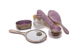 A MATCHED SILVER MOUNTED AND PURPLE ENAMEL SEVEN PIECE DRESSING TABLE SET