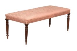 A MAHOGANY FRAMED AND UPHOLSTERED LONG STOOL IN REGENCY STYLE