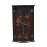 A BLACK AND POLYCHROME LACQUER CORNER CABINET