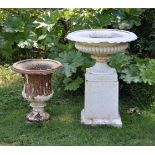 A VICTORIAN WHITE PAINTED CAST IRON CAMPAGNA SHAPED URN ON TAPERING PLINTH