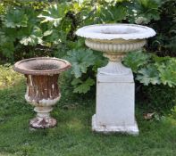 A VICTORIAN WHITE PAINTED CAST IRON CAMPAGNA SHAPED URN ON TAPERING PLINTH