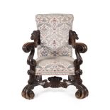 AN ITALIAN CARVED WALNUT AND UPHOLSTERED ARMCHAIR