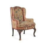 A WALNUT AND NEEDLEWORK UPHOLSTERED WING ARMCHAIR IN GEORGE II STYLE