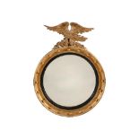 A GILTWOOD AND CONVEX MIRROR IN REGENCY STYLE