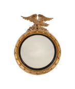 A GILTWOOD AND CONVEX MIRROR IN REGENCY STYLE