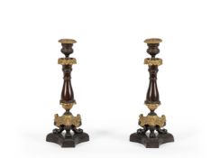 A PAIR OF PATINATED AND GILT METAL CANDLESTICKS IN LOUIS PHILIPPE STYLE